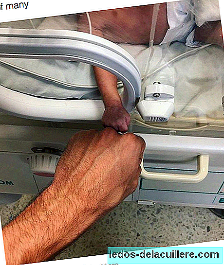 Het emotionele beeld van een premature baby en zijn arts, die in een eenvoudig gebaar de medeplichtigheid overbrengt en vecht voor het leven