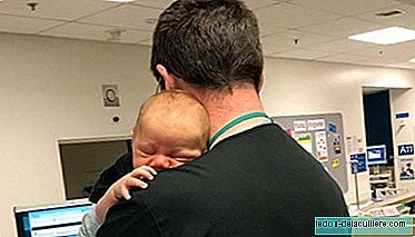 Small gestures that are worth a lot: a doctor comforts a baby in his arms while his mother was tested