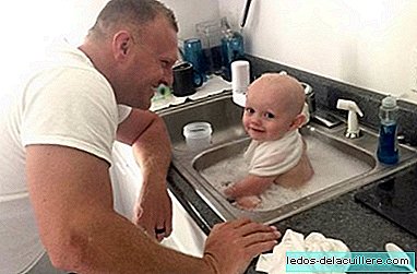 A police officer bathes a baby who was covered in vomit after arresting his mother who was driving drunk