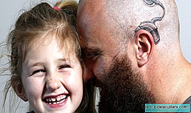 A father tattooes an implant on his head as a show of support for his deaf daughter