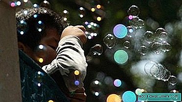 Lovely kids in the park: soap bubbles